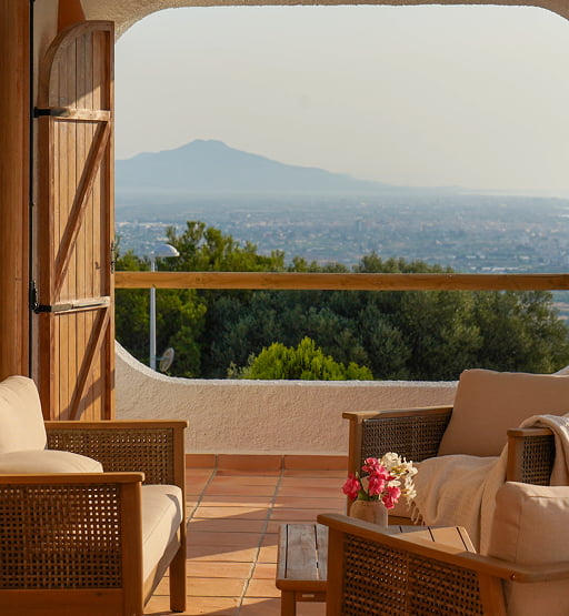 Balcón con sillones y vistas al paisaje.